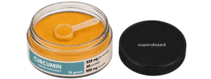 Jar of curcumin supplement with a spoon and 'superdosed' branding on a white background